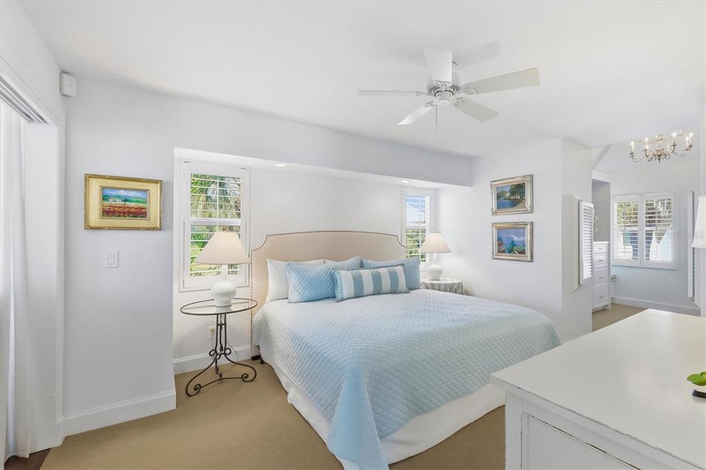 5000 Gasparilla Road, Unit 16 Boca Grande, FL 33921 - Photo 10 of 46 a bedroom with a bed and a chandelier