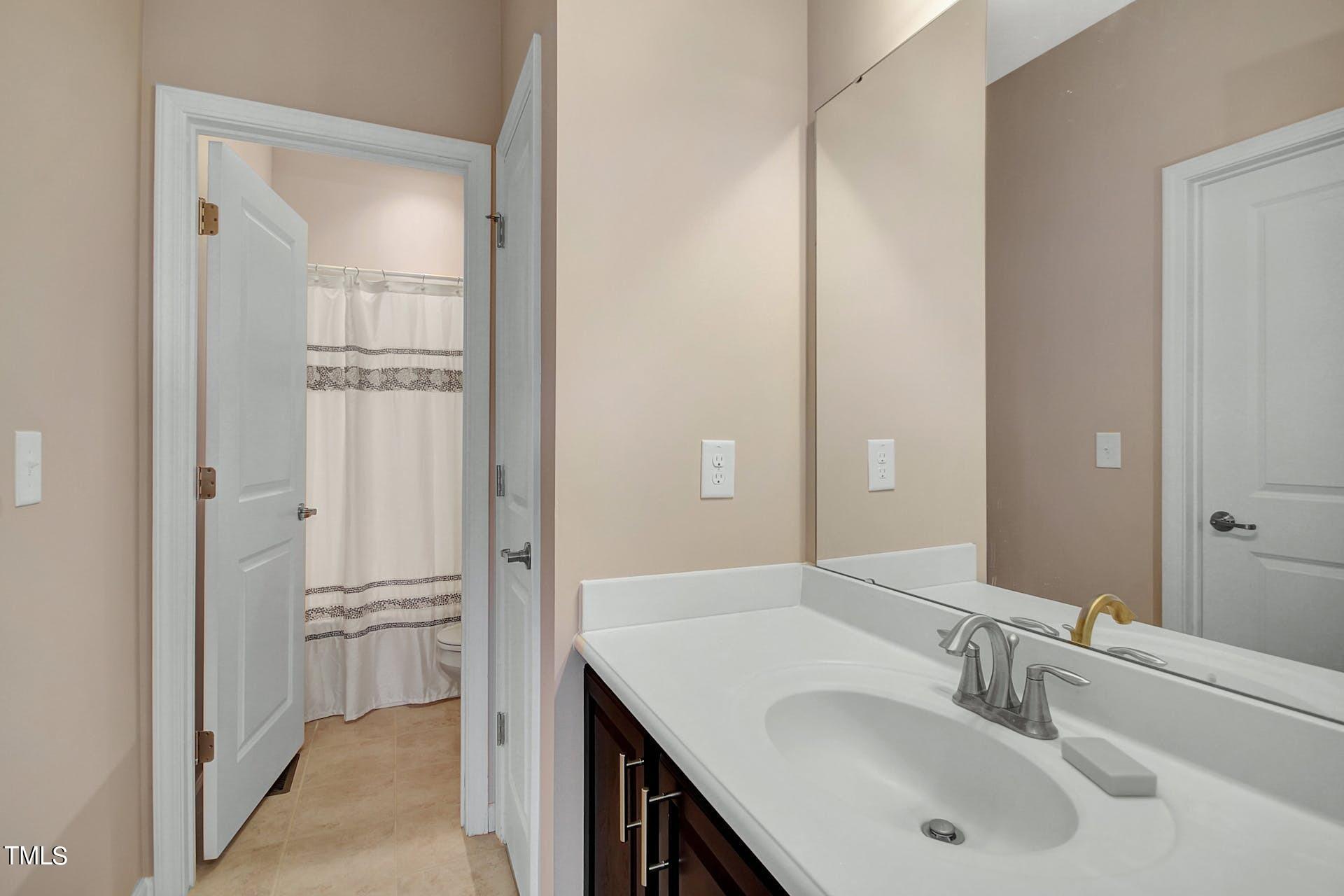 813 Wildflower Ridge Road Wake Forest, NC 27587 - Photo 15 of 16 Guest Bath is Jack and Jill.