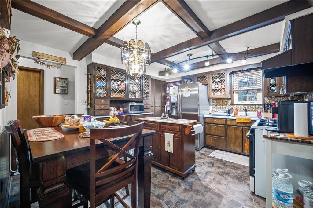 183 Lindley Road Canonsburg, PA 15317 - Photo 17 of 44 a view of a dining room with furniture a chandelier and kitchen view