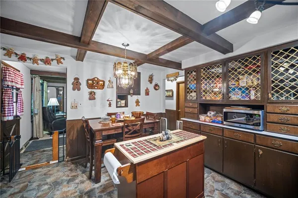 a open kitchen with stainless steel appliances granite countertop a stove and a dining table
