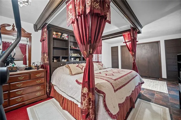 a bed sitting in a bedroom next to a window