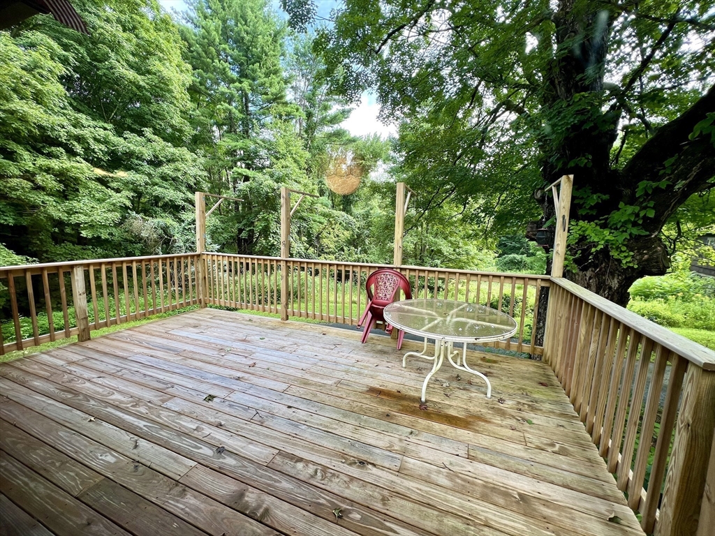 7 Shepard Place Sturbridge, MA 01566 - Photo 10 of 34 a view of a wooden deck with a bench