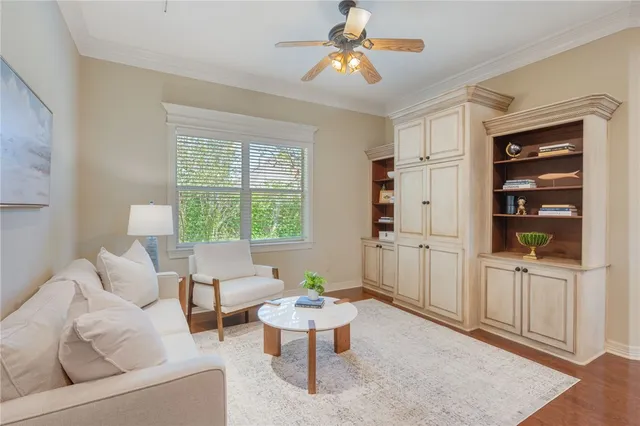 a living room with furniture a chandelier and a window
