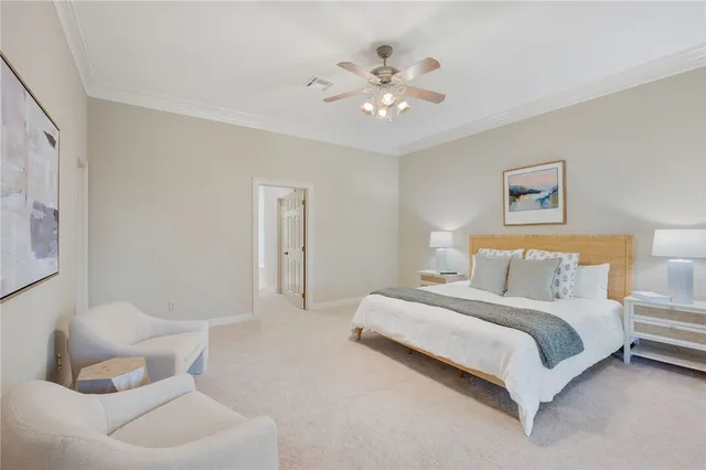 a spacious bedroom with a bed and a chandelier