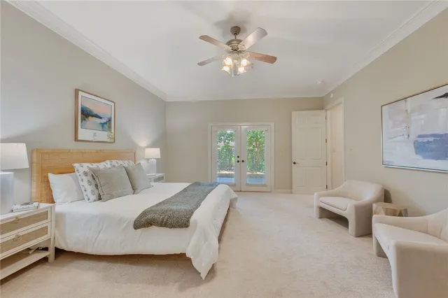 a spacious bedroom with a bed and a chandelier