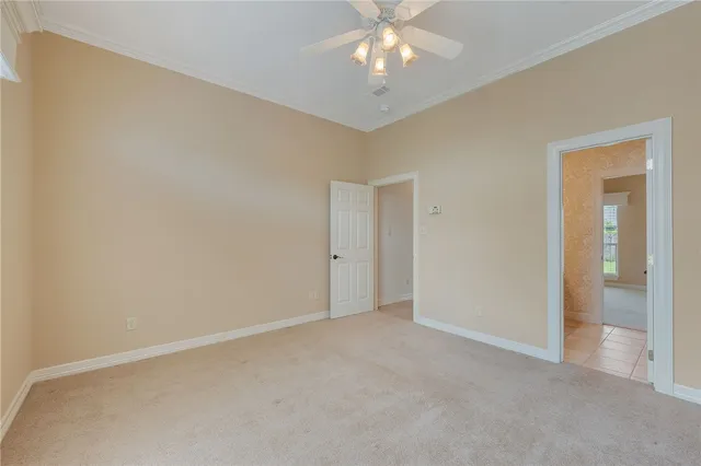 an empty room with a chandelier fan