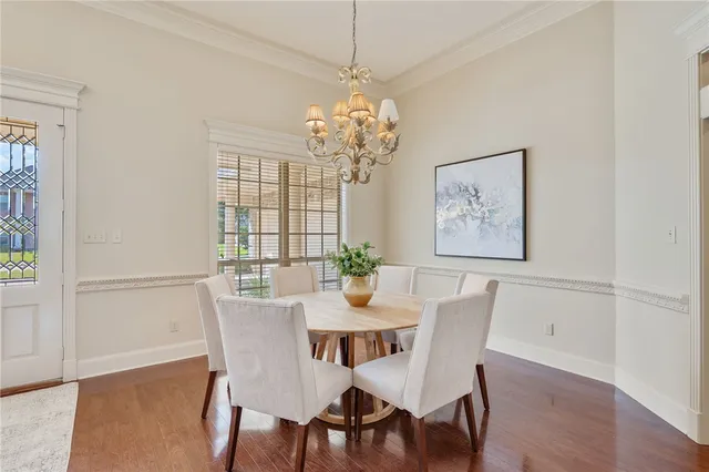 a view of a dining room with furniture wooden floor and a chandelier