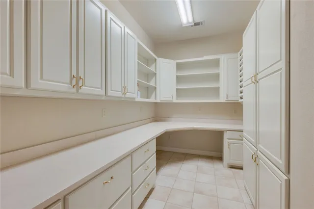 a kitchen with white cabinets and a sink