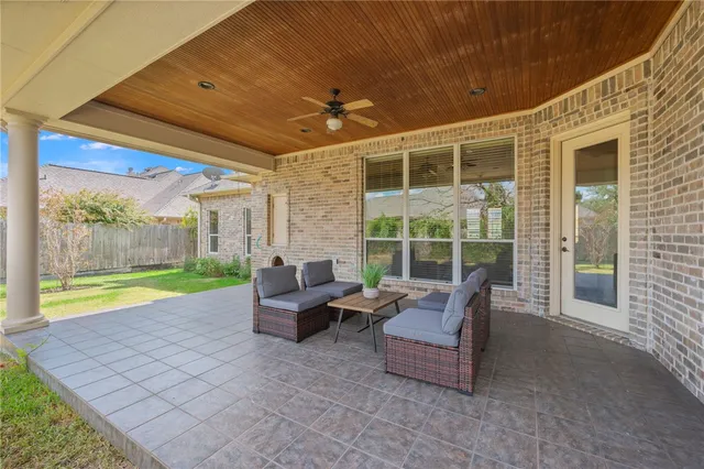 a view of a patio with couches chairs and potted plants