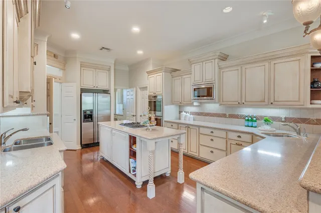 a kitchen with a sink stove and cabinets
