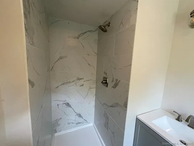 a bathroom with a sink and shower