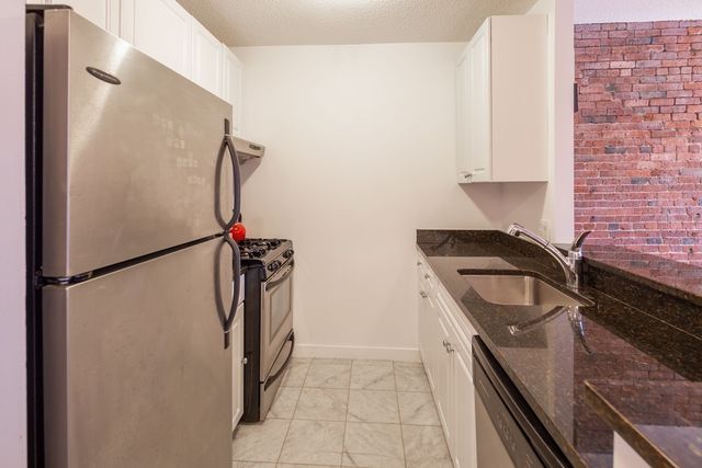 a kitchen with a refrigerator and a sink