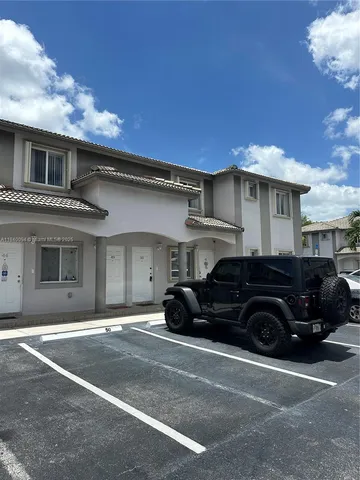 a black car is parked in front of a building