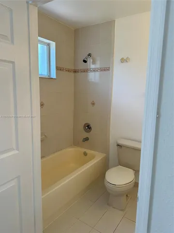 a bathroom with a toilet and a bathtub