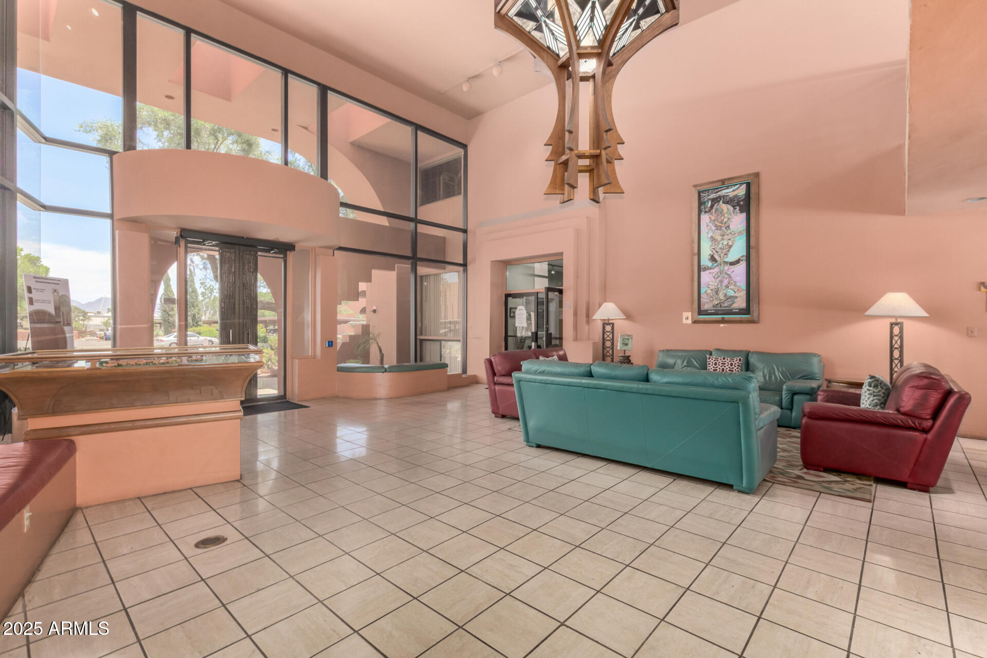 4303 East Cactus Road, Unit 202 Phoenix, AZ 85032 - Photo 30 of 34 a living room with furniture and a chandelier