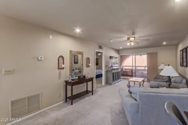 a living room with furniture and a lamp