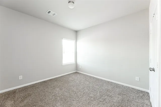 an empty room with a empty space and window