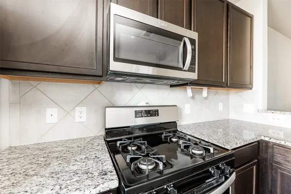 a kitchen with a stove and a microwave