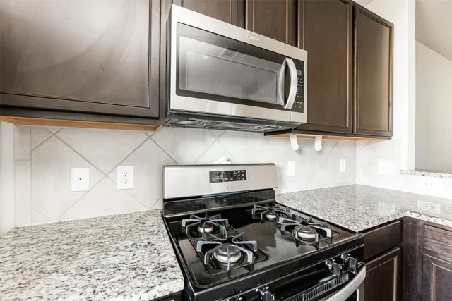 a kitchen with a stove and a microwave