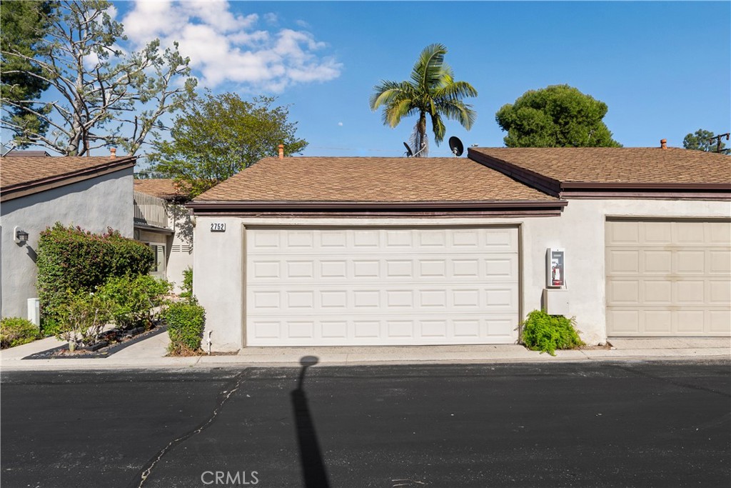 2752 Craig Circle Fullerton, CA 92835 - Photo 2 of 38 a front view of a house with a yard and garage
