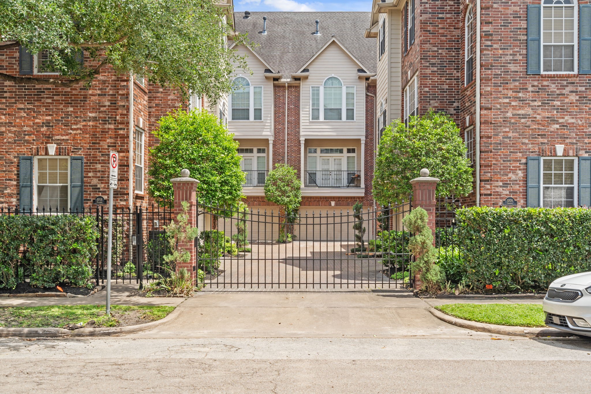 1007 Crocker Street Houston, TX 77019 - Photo 5 of 13 a view of a brick house with plants and large trees