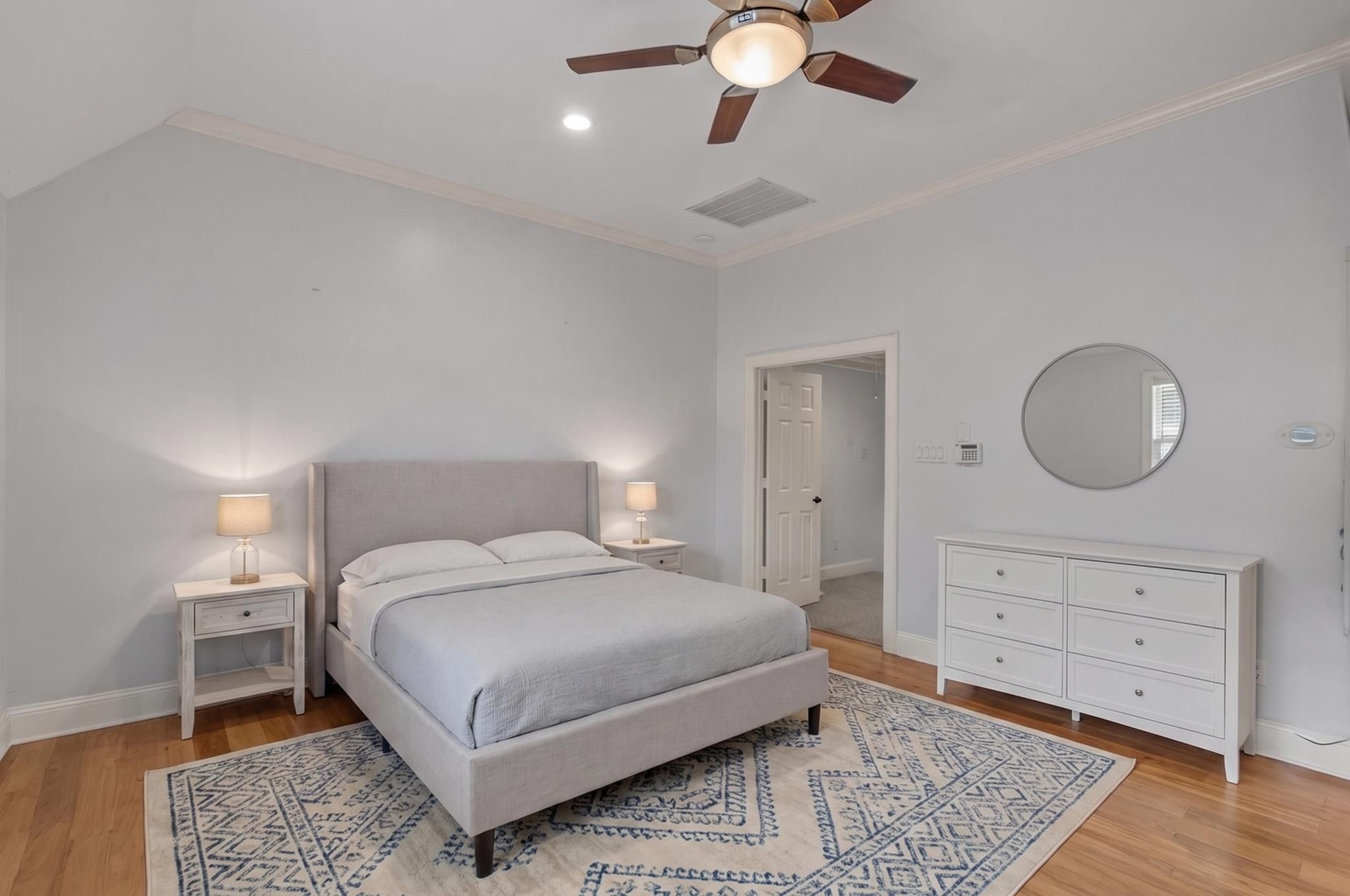 1007 Crocker Street Houston, TX 77019 - Photo 7 of 13 a bedroom with a large bed and a chandelier