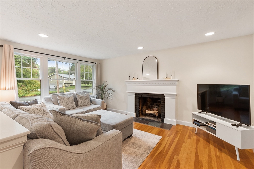 4 Long Meadow Road Chelmsford, MA 01824 - Photo 13 of 30 a living room with furniture a flat screen tv and a fireplace