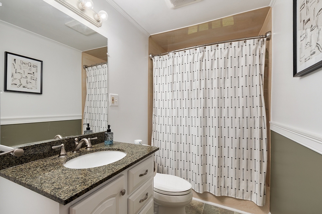 4 Long Meadow Road Chelmsford, MA 01824 - Photo 20 of 30 a bathroom with a granite countertop toilet sink and mirror