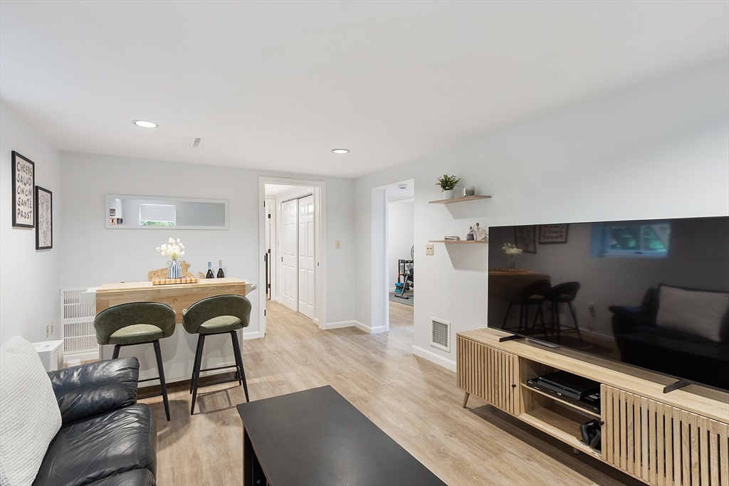 4 Long Meadow Road Chelmsford, MA 01824 - Photo 21 of 30 a living room with furniture a fireplace and a kitchen view