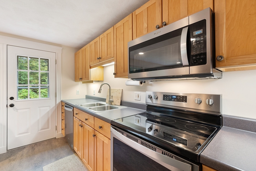 4 Long Meadow Road Chelmsford, MA 01824 - Photo 8 of 30 a kitchen with a stove and a microwave