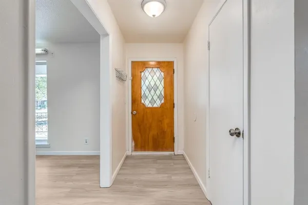 a view of a hallway with wooden floor and a hallway