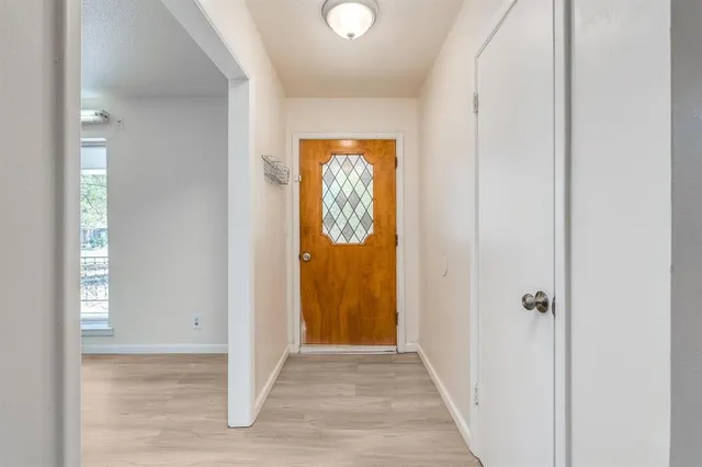 a view of a hallway with wooden floor and a hallway