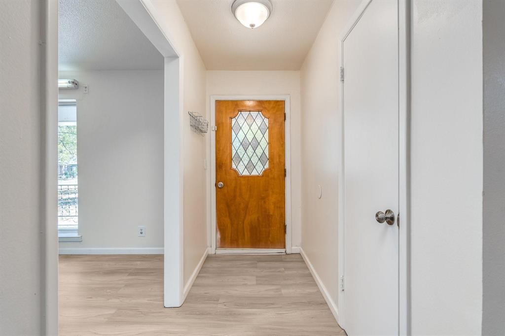 921 Evans Street Bonham, TX 75418 - Photo 20 of 28 a view of a hallway with wooden floor and a hallway