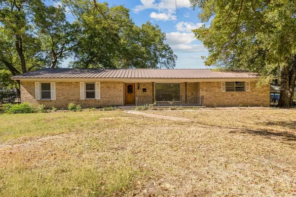a house that has a tree in front of it