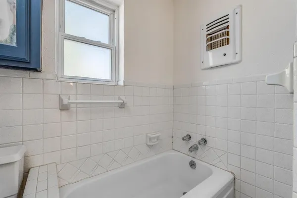 a bathroom with a bathtub and shower