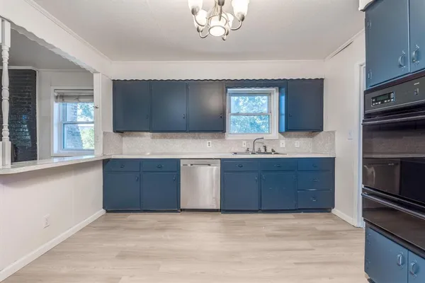 a kitchen with a sink stove and microwave