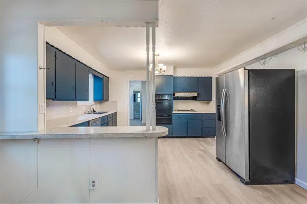 a kitchen with stainless steel appliances a refrigerator and a sink
