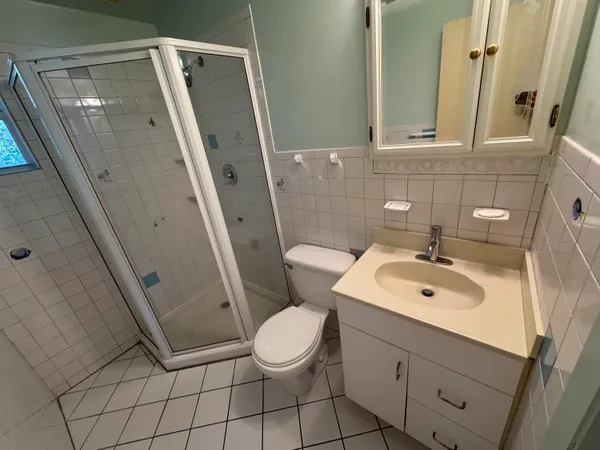 an empty room with a window and a ceiling fan