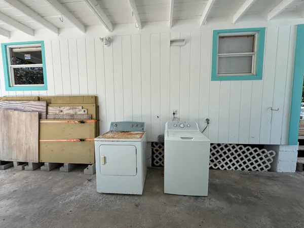 a view of kitchen with a sink and cabinets