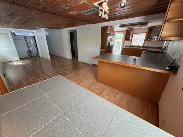 a view of a living room with wooden floor