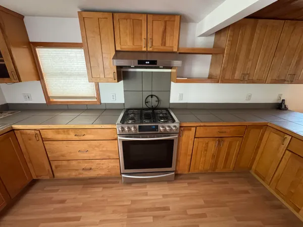 a kitchen with granite countertop a stove and a sink