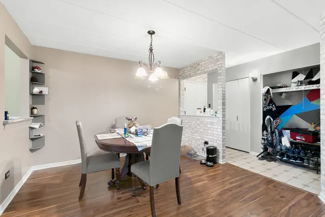 a dining room with furniture and wooden floor