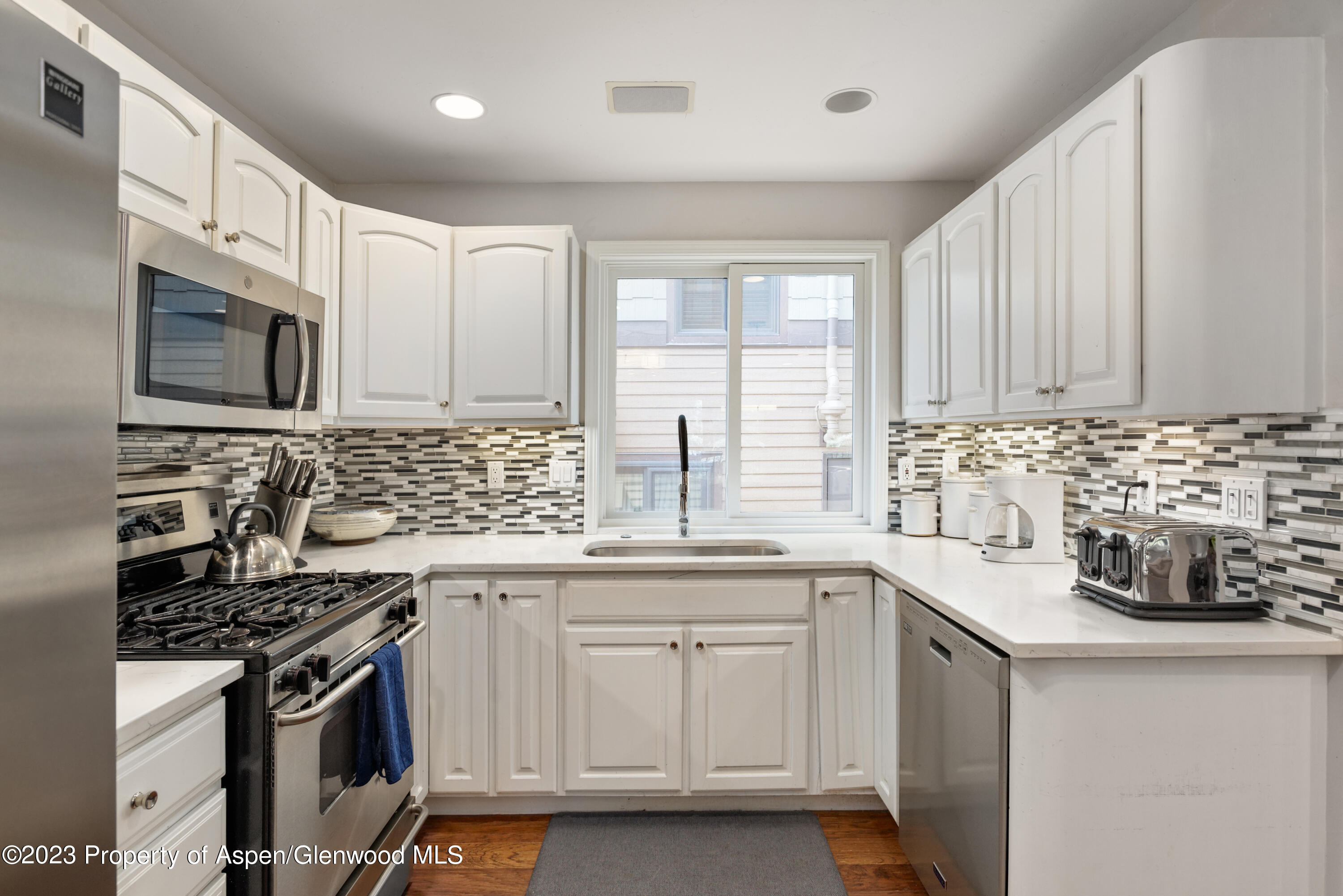 650 South Monarch Street, Unit 2 Aspen, CO 81611 - Photo 3 of 21 a kitchen with stainless steel appliances a sink a stove and cabinets