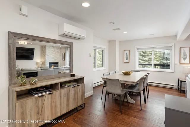 a view of a dining room with furniture and wooden floor