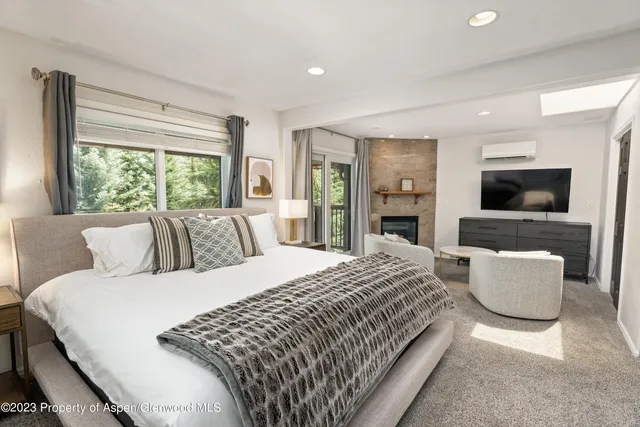 a bedroom with a large bed and a flat screen tv