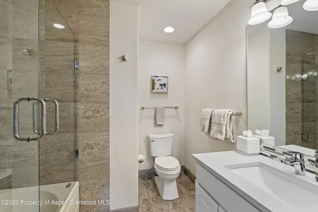 a bathroom with a toilet sink and shower