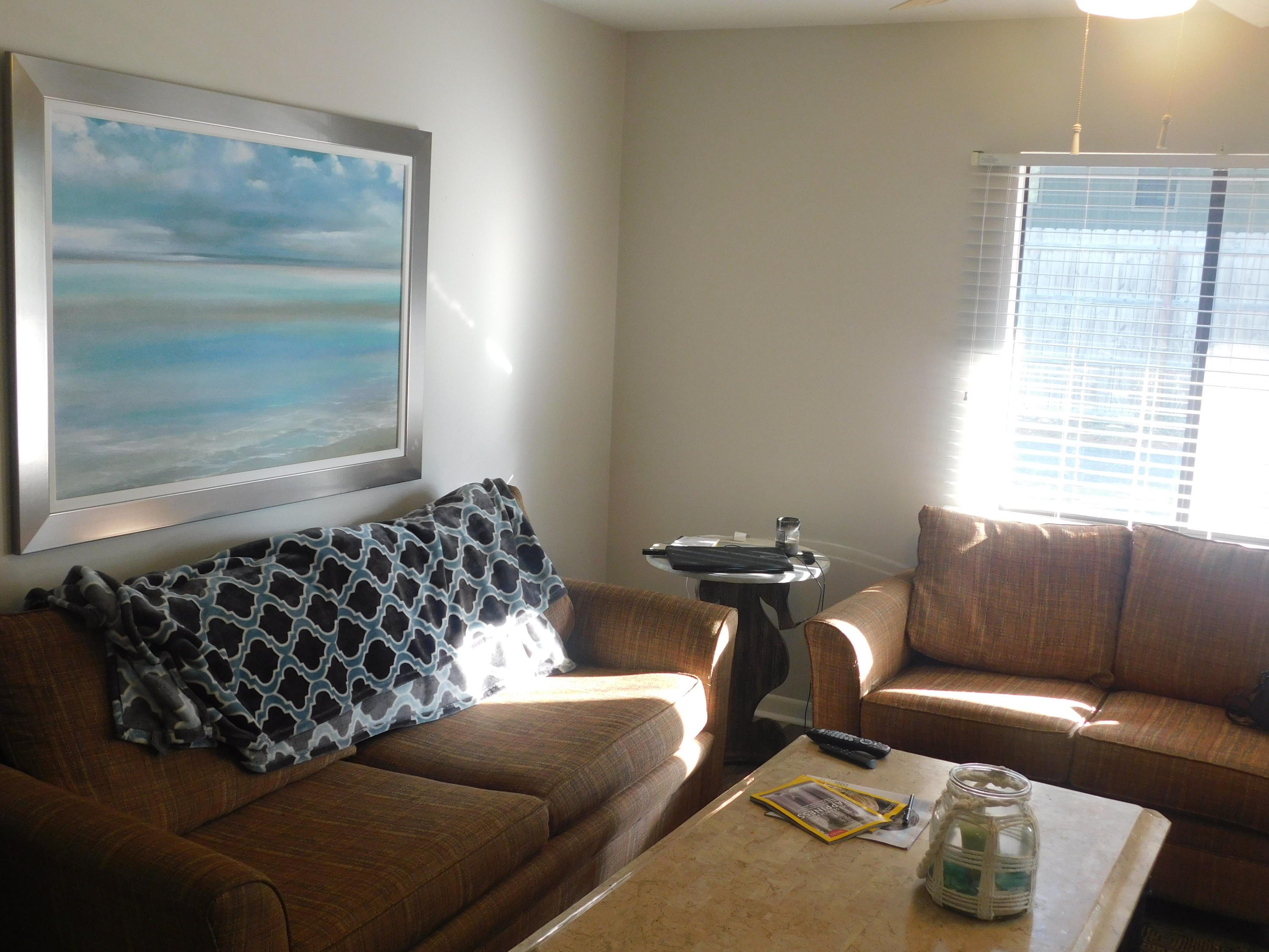 144 My Way, Unit A Santa Rosa Beach, FL 32459 - Photo 8 of 25 a living room with a couch and a window
