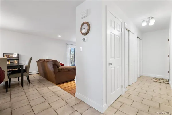 a living room with furniture a clock and a table