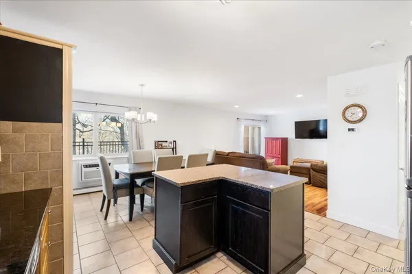 a large kitchen with kitchen island a sink table and chairs