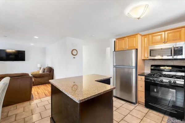 a open kitchen with stainless steel appliances granite countertop a sink and cabinets
